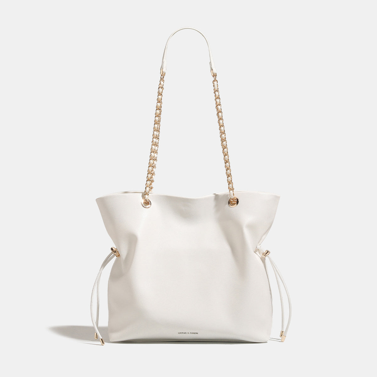 Soft-structured leather-look tote bag with gold-tone chain-and-strap shoulder handles and side drawstring cinches, detail
