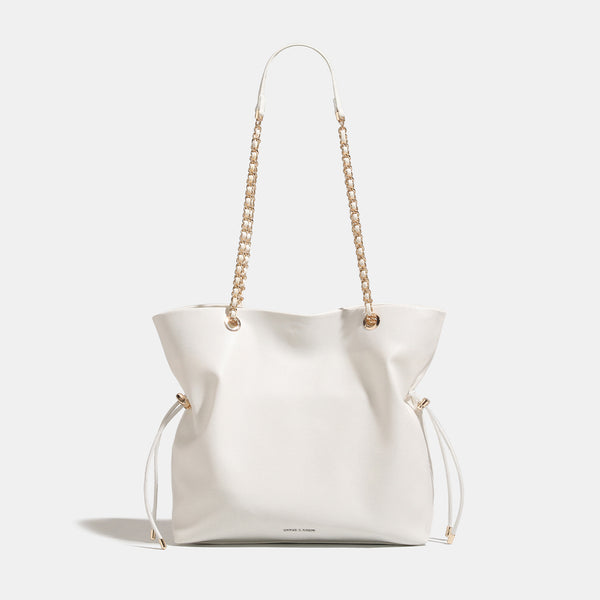 Soft-structured leather-look tote bag with gold-tone chain-and-strap shoulder handles and side drawstring cinches, detail