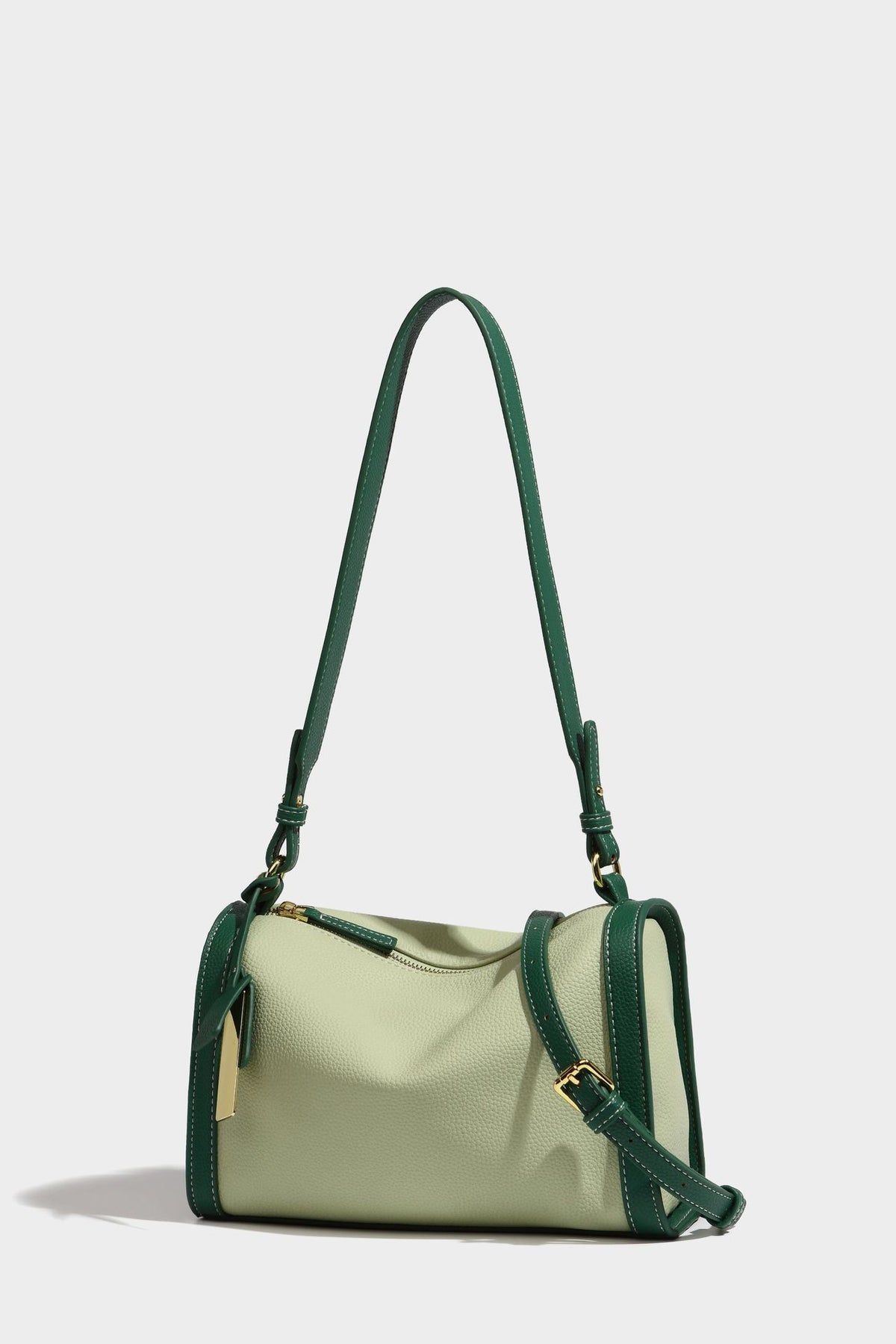 Structured two-tone shoulder bag with pebbled leather-look finish, contrast trim, top zip closure, and gold-tone hardware