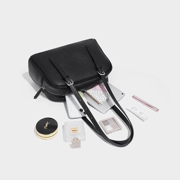 Structured dome-shaped shoulder bag with leather-look finish, top zipper closure, dual adjustable slim straps, and, detail