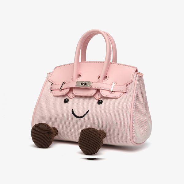 Small structured trapezoid satchel bag with smiling face motif, pom-pom accents, brown leather-look trim, silver-tone, detail