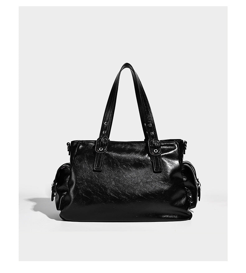 Glossy structured black tote shoulder bag with silver buckle hardware, zip pockets, dual top handles, and detachable, detail