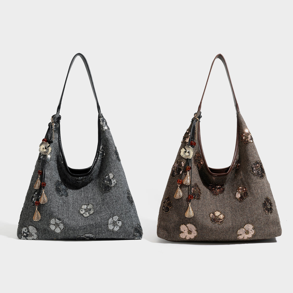 Slouchy trapezoid shoulder tote in charcoal gray with silver sequin floral motifs, leather-look strap, and dangling beaded