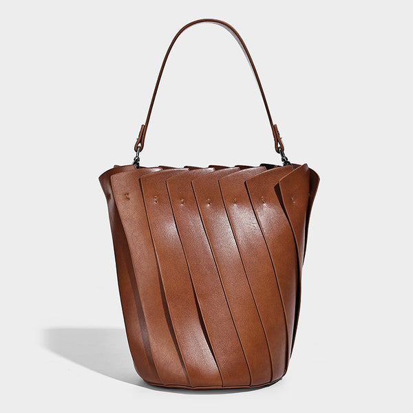Structured pleated-panel bucket bag with curved top handle and detachable adjustable shoulder strap in smooth matte, detail