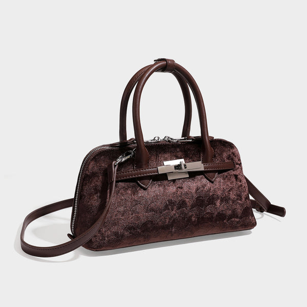 Small structured satchel bag in dark brown velvet-like textured finish with leather-look trim, silver-tone turn-lock bar