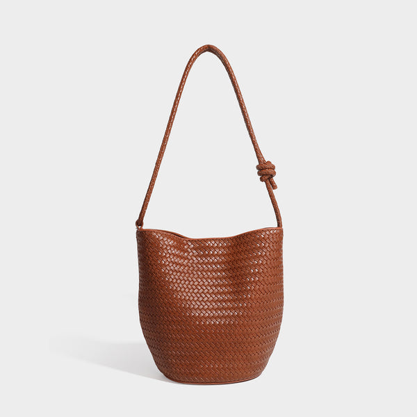 Olive green woven leather-look bucket bag with braided crossbody strap, knotted adjustment, and gold-tone tassel charm with