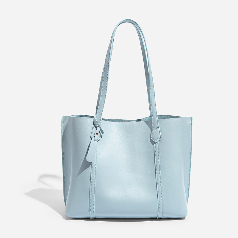 Large structured leather-look tote bag with belt-strap detail and gold-tone hardware, detail view 9