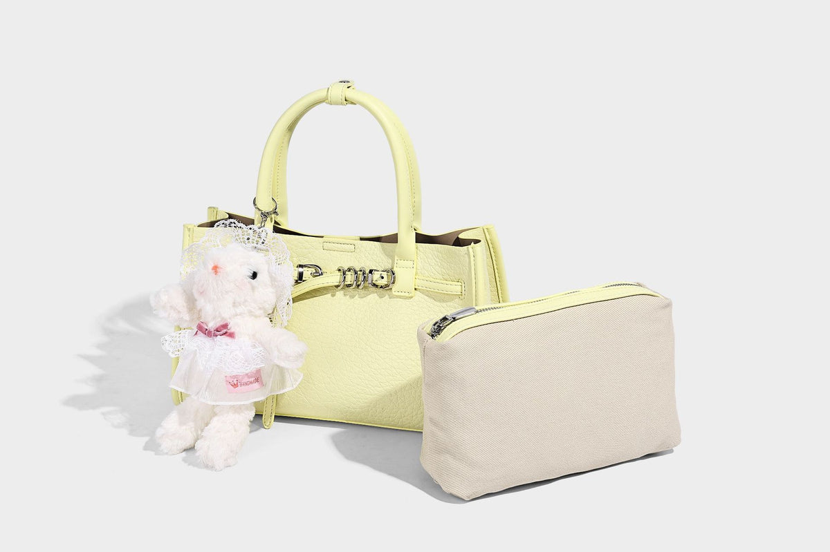 Structured trapezoid tote bag in pebbled leather-look finish with double top handles, silver-tone bar hardware, and, detail