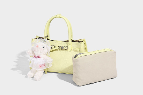 Structured trapezoid tote bag in pebbled leather-look finish with double top handles, silver-tone bar hardware, and, detail