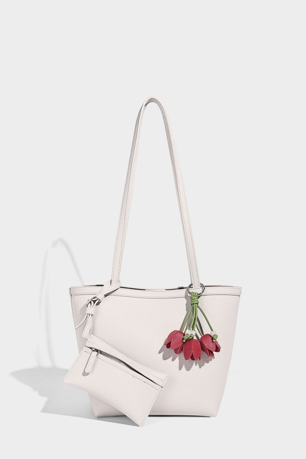 Structured pebbled leather-look tote bag in taupe with long shoulder strap, detachable zip pouch, and pink tulip flower