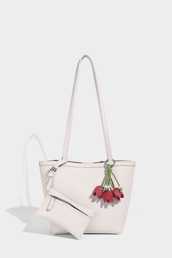 Structured pebbled leather-look tote bag in taupe with long shoulder strap, detachable zip pouch, and pink tulip flower
