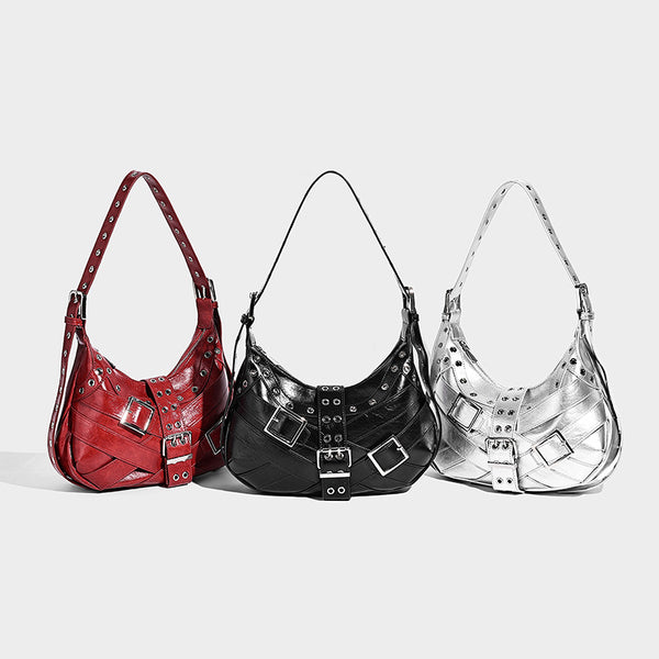 Glossy crescent hobo bag with silver-tone grommets, square buckle straps, and top zipper closure, detail view 2