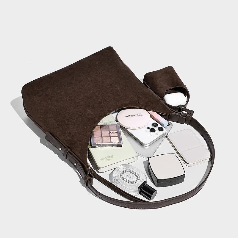 Dark brown suede-look hobo shoulder bag with top zip closure, adjustable strap, and small detachable mini pouch, detail view