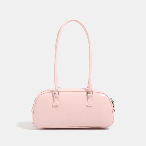 Rounded baguette shoulder bag with glossy leather-look finish, double-pull zip top, dual top handles, and silver-tone, detail