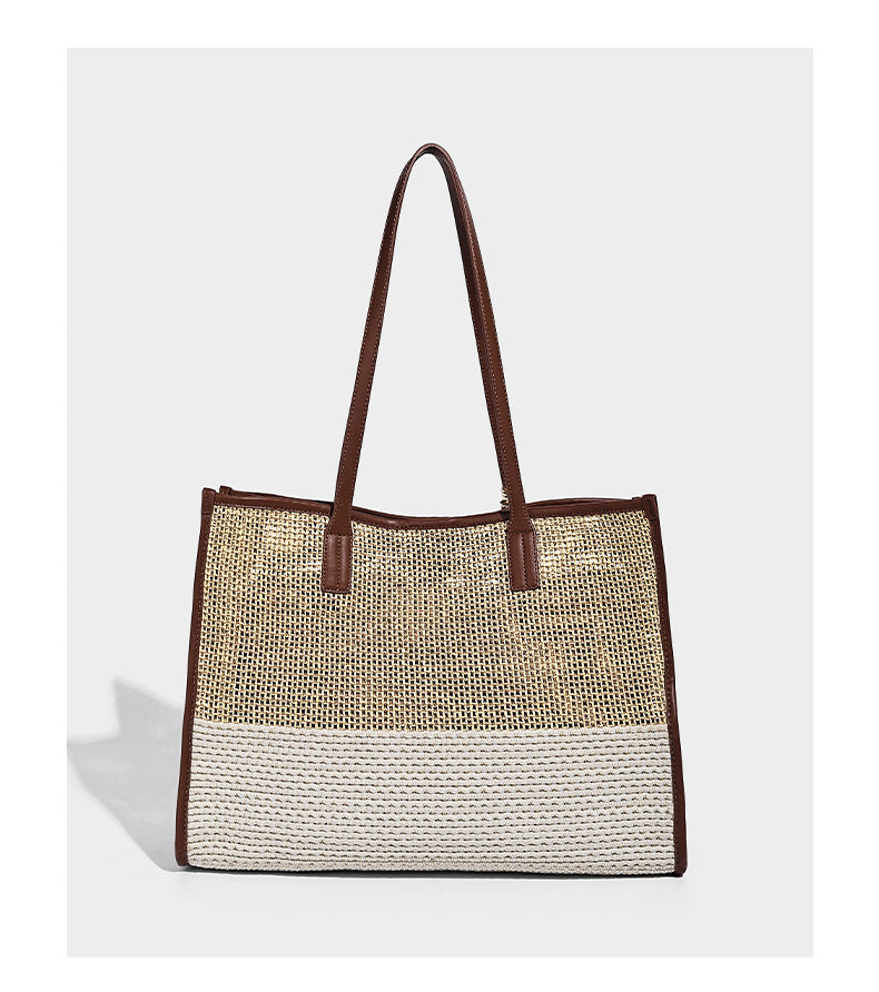Two-tone woven straw tote bag with leather-look brown trim, long shoulder straps, and knotted tassel charm, detail view 12