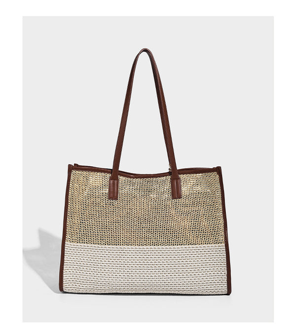 Two-tone woven straw tote bag with leather-look brown trim, long shoulder straps, and knotted tassel charm, detail view 12