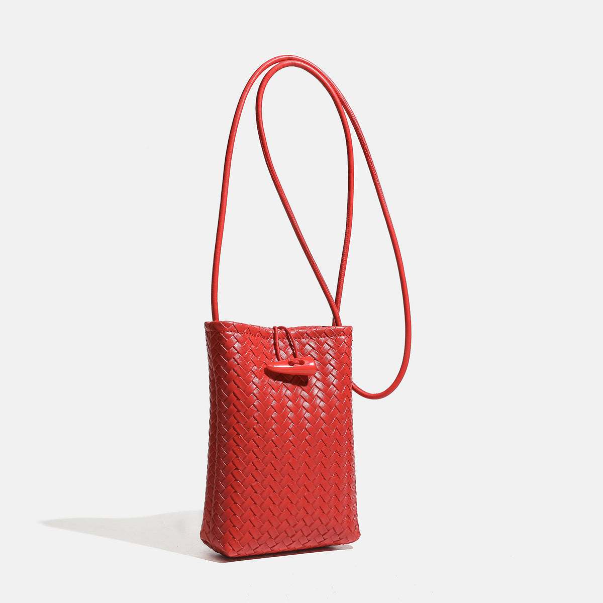 Compact woven leather-look bucket crossbody pouch with toggle closure and long fixed strap, detail view 2