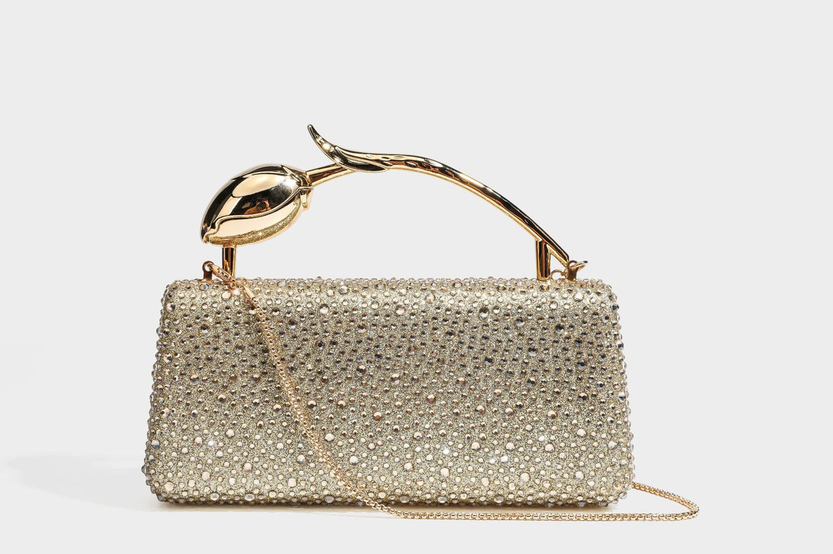 rectangular hard-case rhinestone evening clutch with sculptural gold-tone branch-and-bud top handle and detachable chain