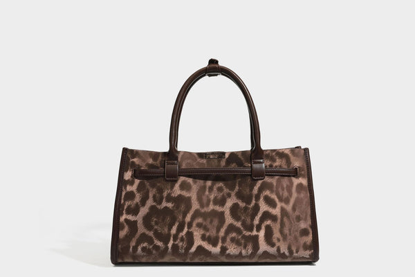 Structured leopard-print tote bag with glossy satin-like finish, dual rounded top handles, silver buckle-and-ring front