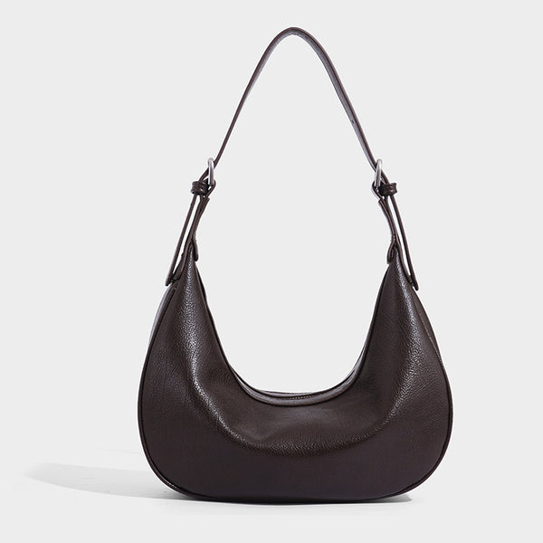 Crescent half-moon shoulder bag in pebbled leather-look finish with adjustable strap and silver-tone hardware, detail view 8