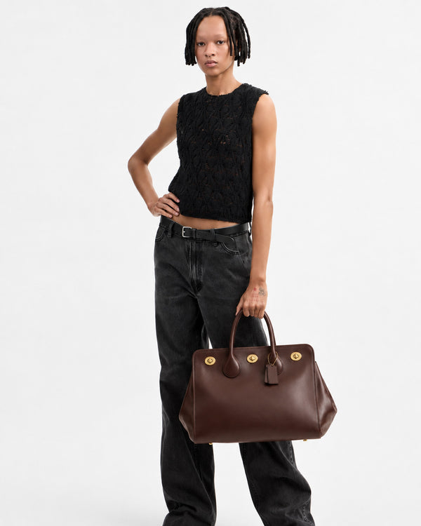 Structured leather-look tote bag with three gold-tone turn-lock closures and double rolled top handles, detail view 9