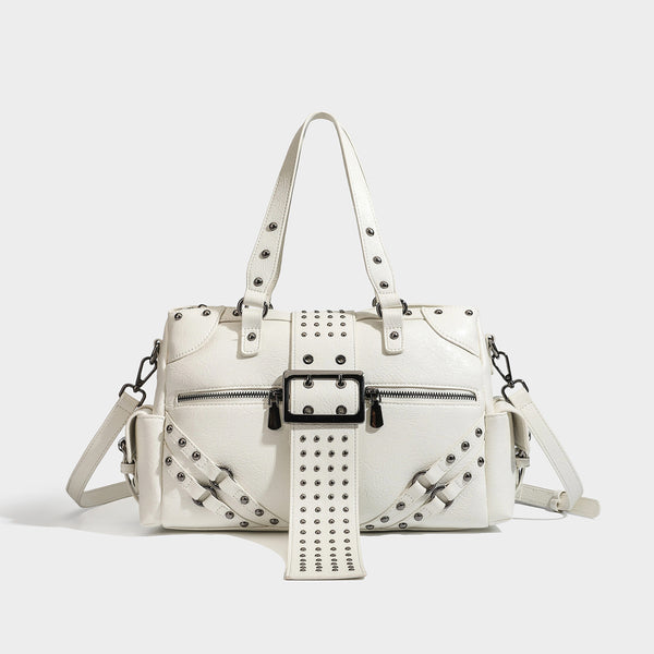 Structured pink leather-look satchel bag with gunmetal studded trim, rectangular buckle strap, dual top handles, and, front