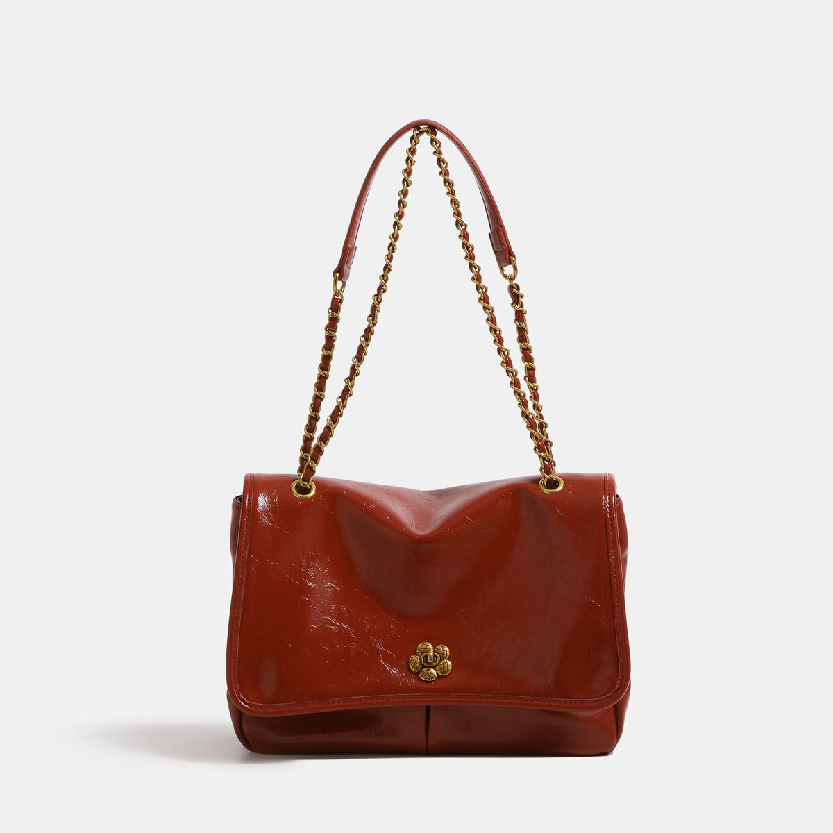 Structured flap shoulder bag with antique gold-tone chain strap and flower turn-lock clasp in crinkled leather-look finish