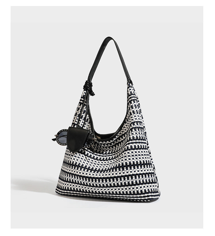 Slouchy woven stripe hobo shoulder bag with black-and-white pattern and leather-look strap, detail view 8