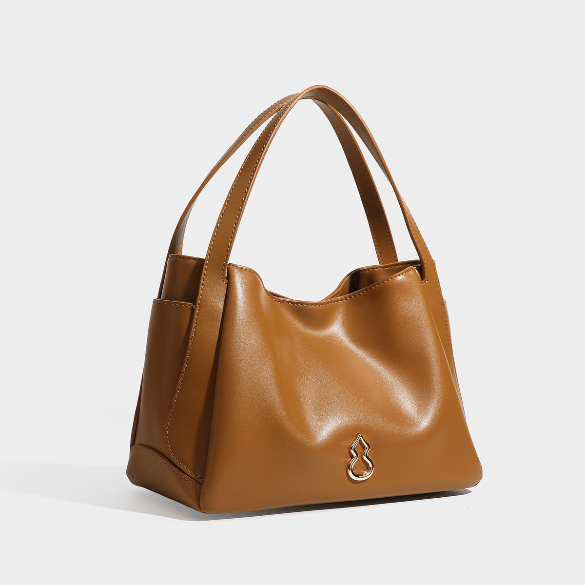 Structured glossy leather-look tote shoulder bag with dual top handles, detachable crossbody strap, side pockets, and, detail