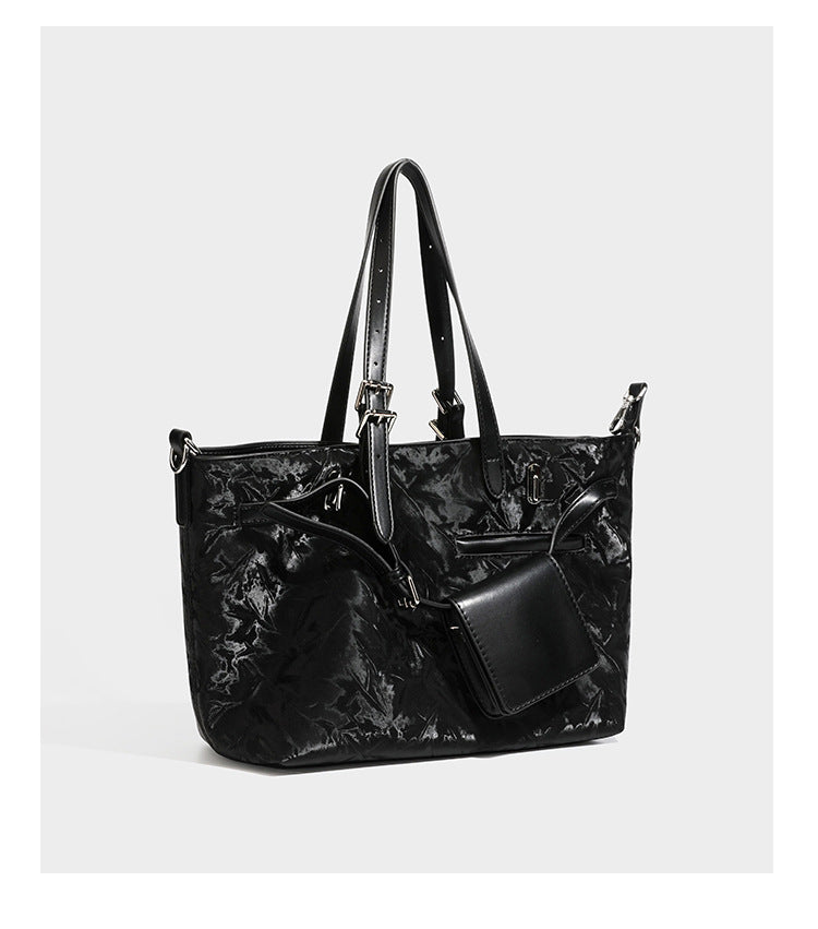 Glossy crinkled metallic-finish tote bag in brown with smooth leather-look top handles, silver-tone hardware, and attached