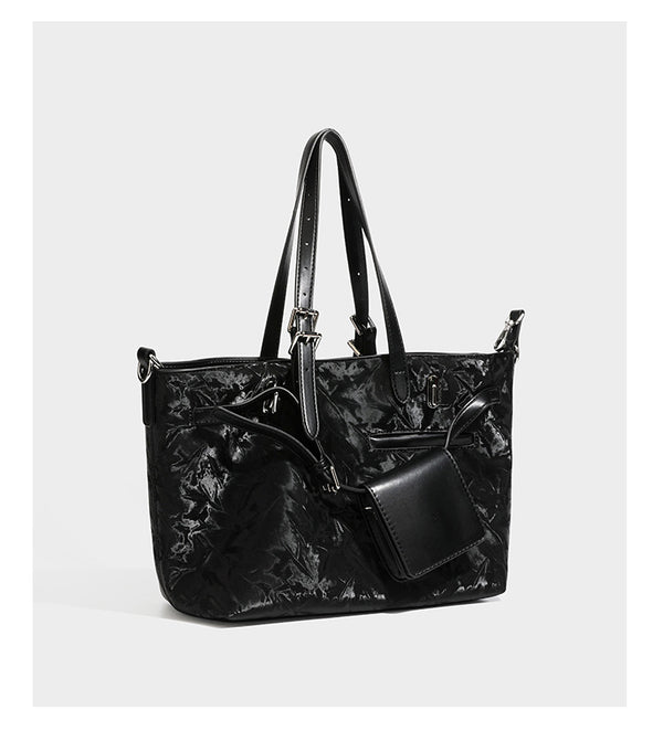 Glossy crinkled metallic-finish tote bag in brown with smooth leather-look top handles, silver-tone hardware, and attached