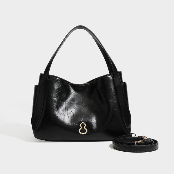 Black glossy crinkled leather-look convertible shoulder tote bag with gold gourd-shaped emblem hardware and detachable