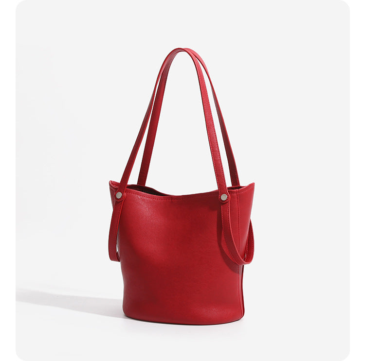 Large leather-look bucket tote bag with dual top handles and adjustable crossbody strap, detail view 14