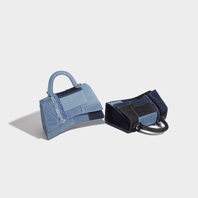 Structured patchwork denim trapezoid satchel bag with frayed panel trim, rounded top handle, and silver-tone hardware, detail