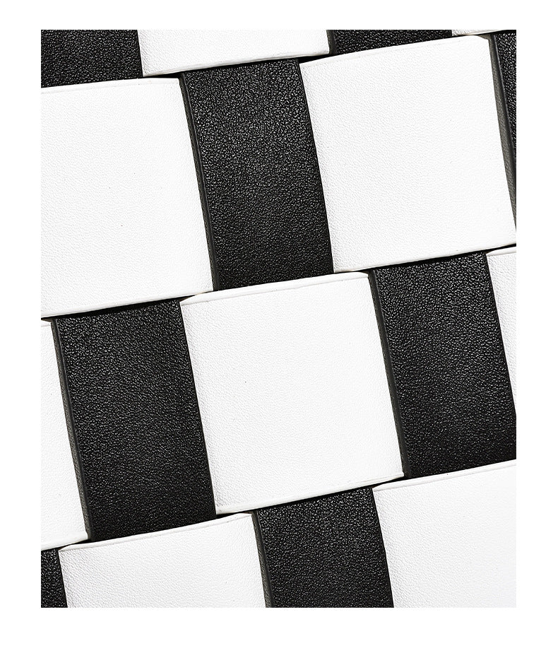 Hand-woven black-and-white checkerboard bucket bag with smooth black trim, silver-tone ring hardware, and adjustable