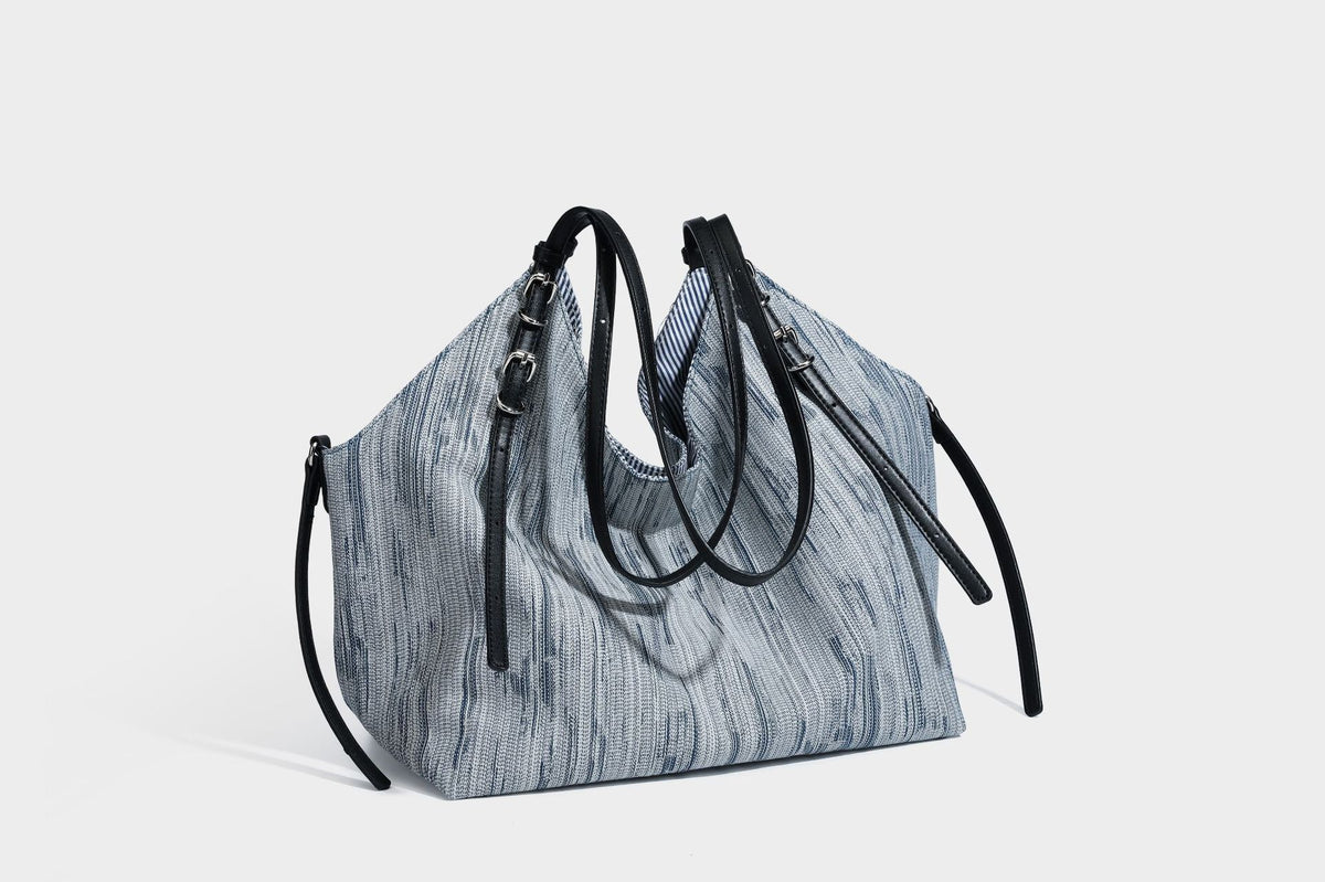 Large slouchy woven-texture shoulder tote bag with slim leather-look straps, side cinch ties, and silver-tone hardware
