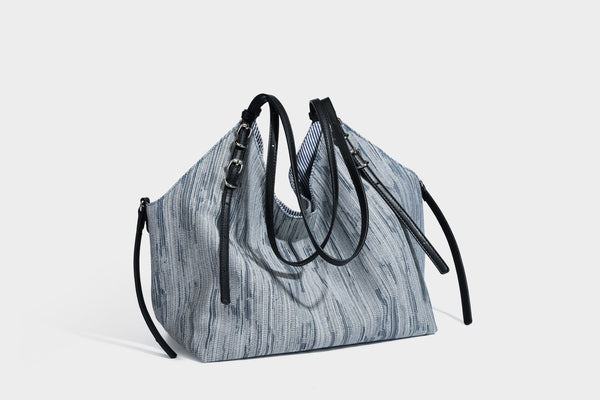 Large slouchy woven-texture shoulder tote bag with slim leather-look straps, side cinch ties, and silver-tone hardware