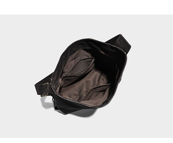 Large slouchy hobo shoulder bag in matte leather-look finish with adjustable strap and gold-tone bar hardware, detail view 9