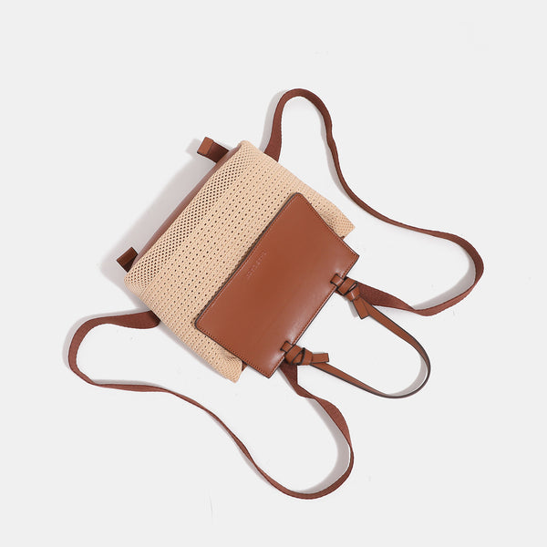 Structured woven tote bag with smooth leather-look front flap panel, knotted top handles, and detachable crossbody strap