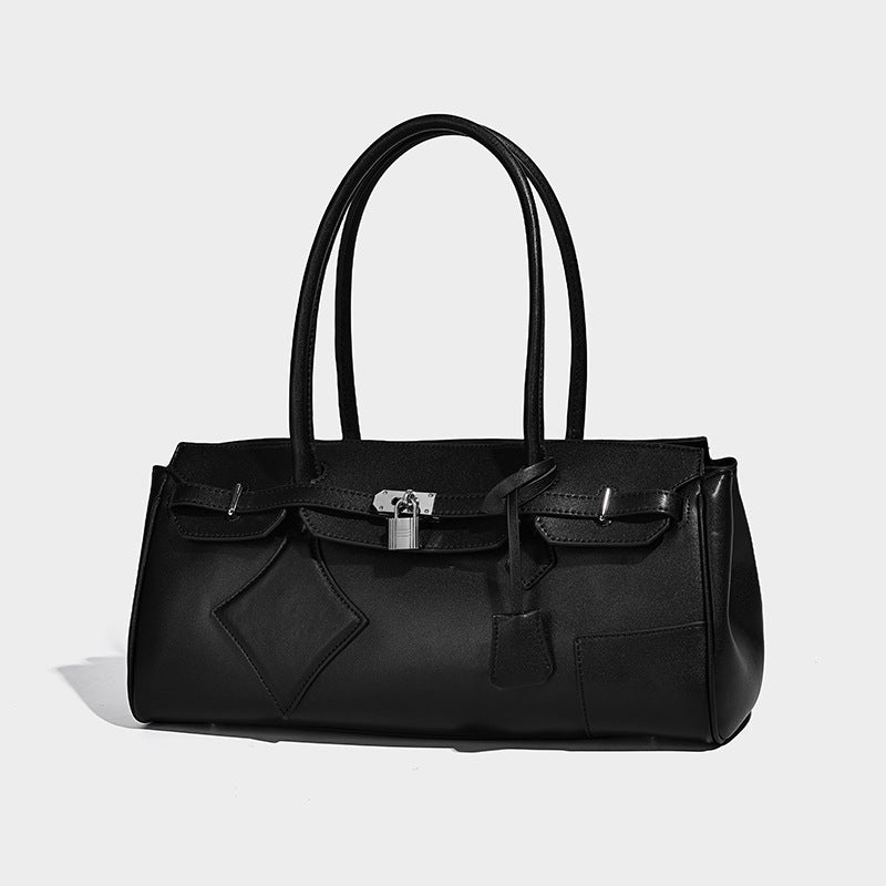 Structured black leather-look tote bag with padlock turn-lock hardware, decorative strap detailing, and rounded double top