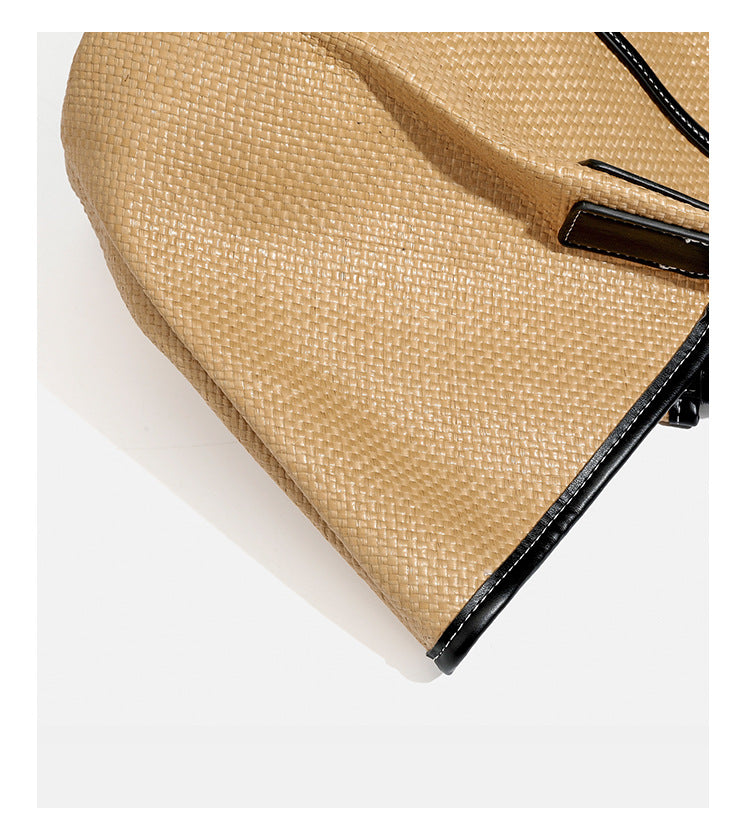 Tan woven tote bag with contrasting leather-look trim, long shoulder straps, and detachable rectangular zip pouch, detail