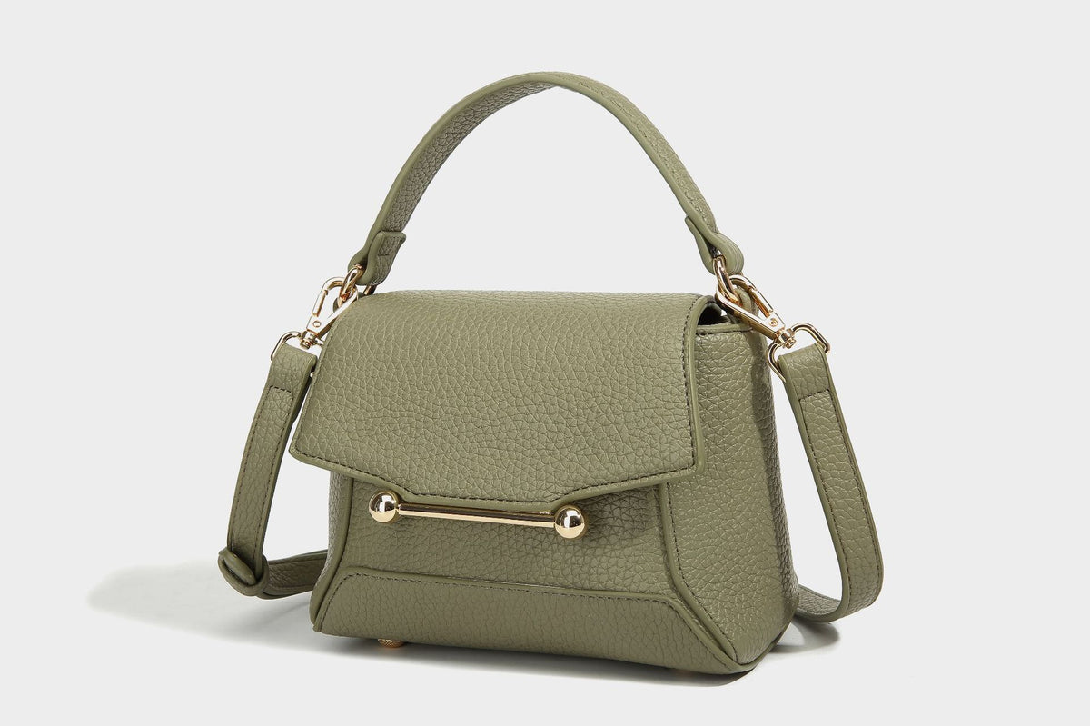 Small structured pebbled flap mini satchel with gold-tone bar hardware, short top handle, and detachable crossbody strap