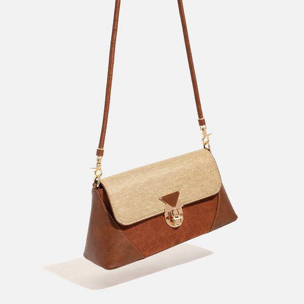 Structured trapezoid shoulder bag with pale textured flap, gold-tone triangular turn-lock closure, and long knotted cord
