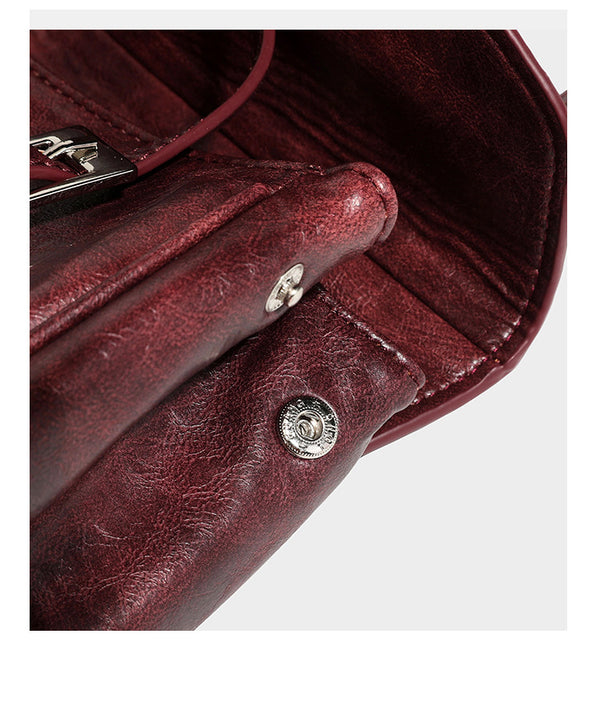 Structured flap-top shoulder tote bag in distressed leather-look finish with silver-tone buckle hardware and double shoulder