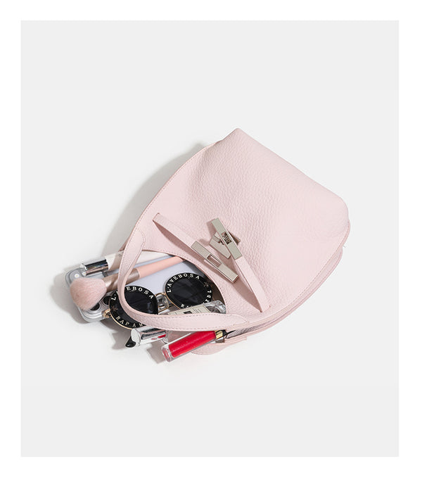 Compact pebbled leather-look shoulder bag with crossed silver-toned metal front closure, short top handle, and long, detail