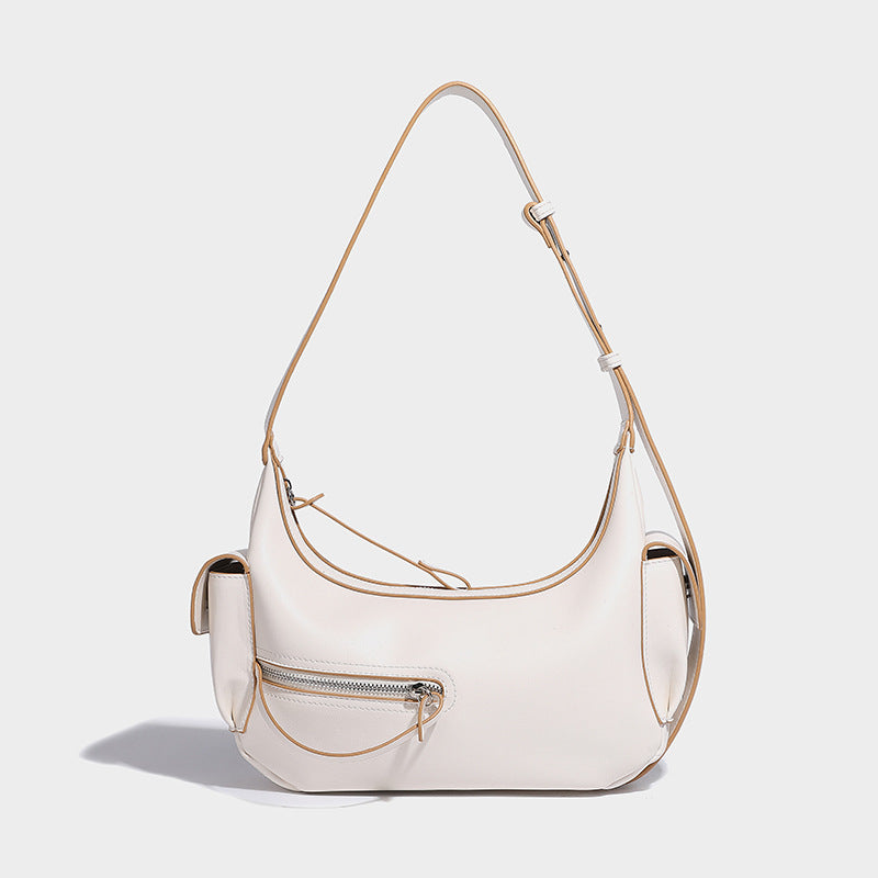 Smooth leather-look crescent shoulder bag with front zip pocket, side flap pockets, adjustable strap, and silver-tone, detail