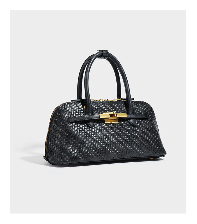 Structured woven-embossed leather-look satchel with dual rolled top handles, gold-tone turn-lock closure, and detachable