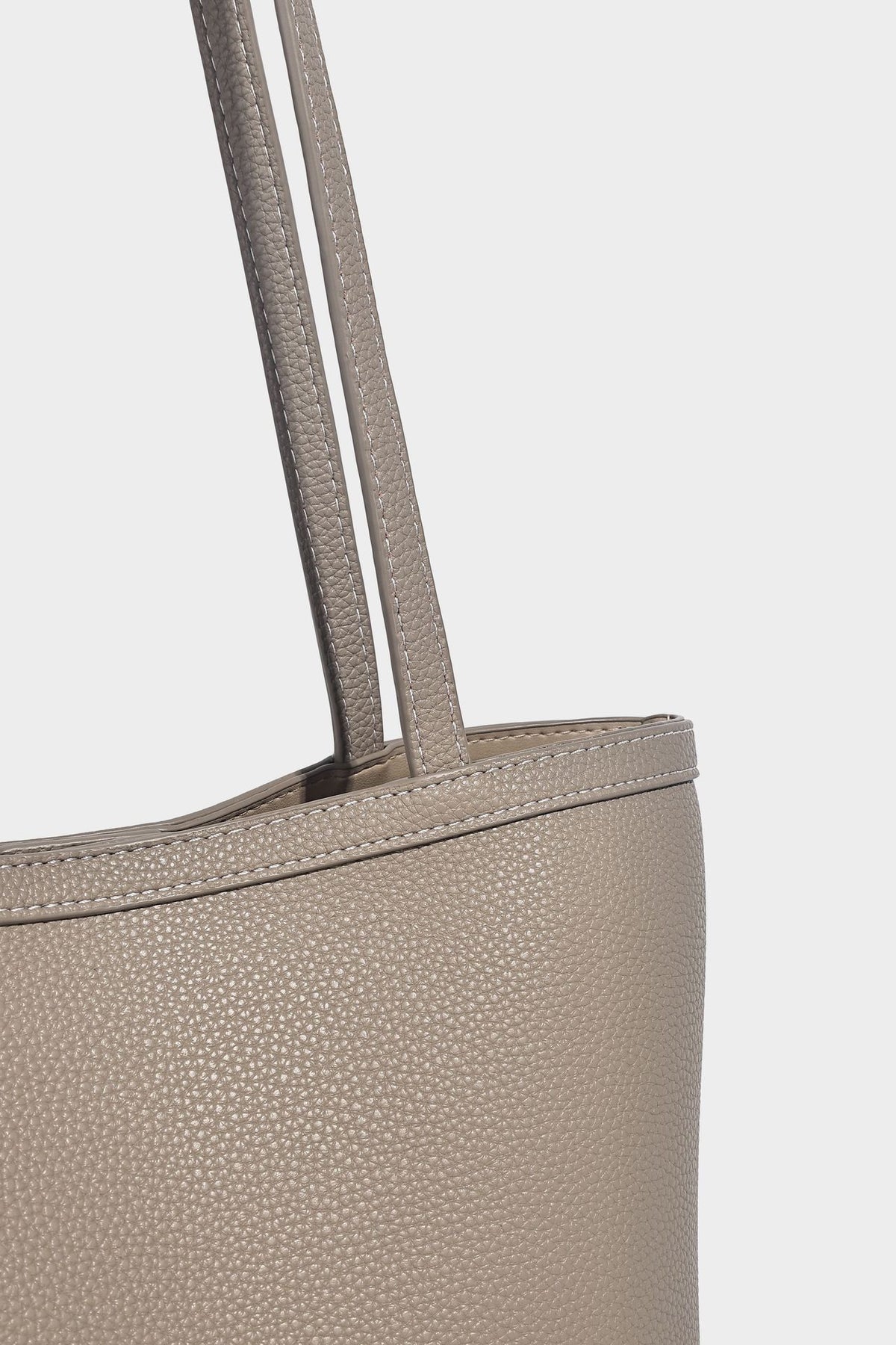 Structured pebbled leather-look tote bag in taupe with long shoulder strap, detachable zip pouch, and pink tulip flower