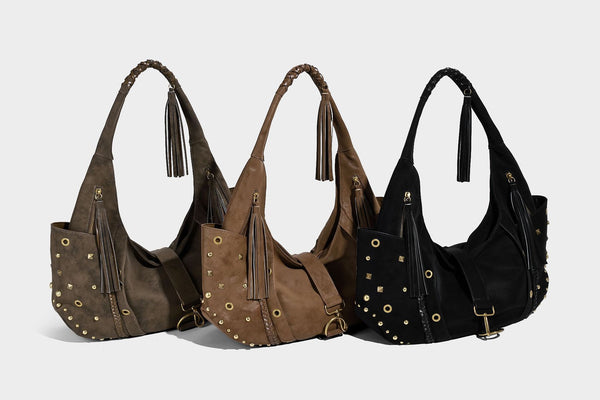 Slouchy crescent hobo bag in matte brown suede-like finish with gold-tone studs, grommets, braided top handle, tassel side