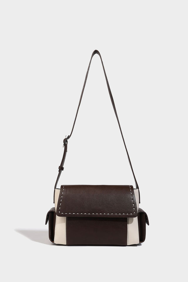 Structured flap crossbody bag in dark brown and cream color-block with white contrast stitching, adjustable shoulder strap